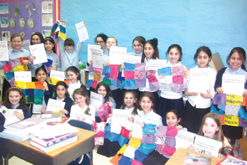 New York Author and Storytellers Honored: Classroom of students holding their Grannie Annie stories and quilt blocks