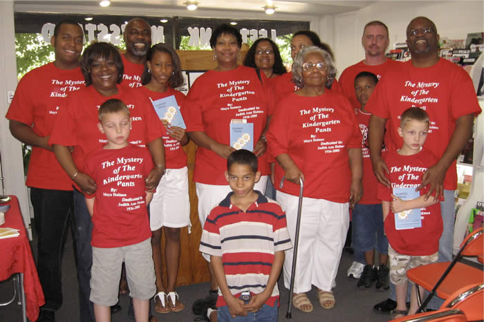 Grannie Annie author and family in matching red T-shirts celebrating their family's story